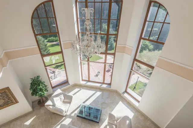 A tall living room with floor-to-ceiling windows
