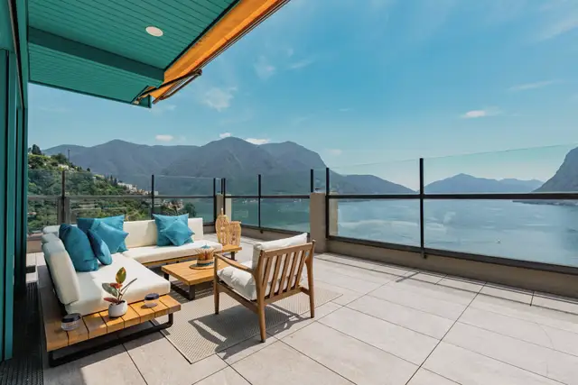 A stone terrace overlooking a lake and mountains